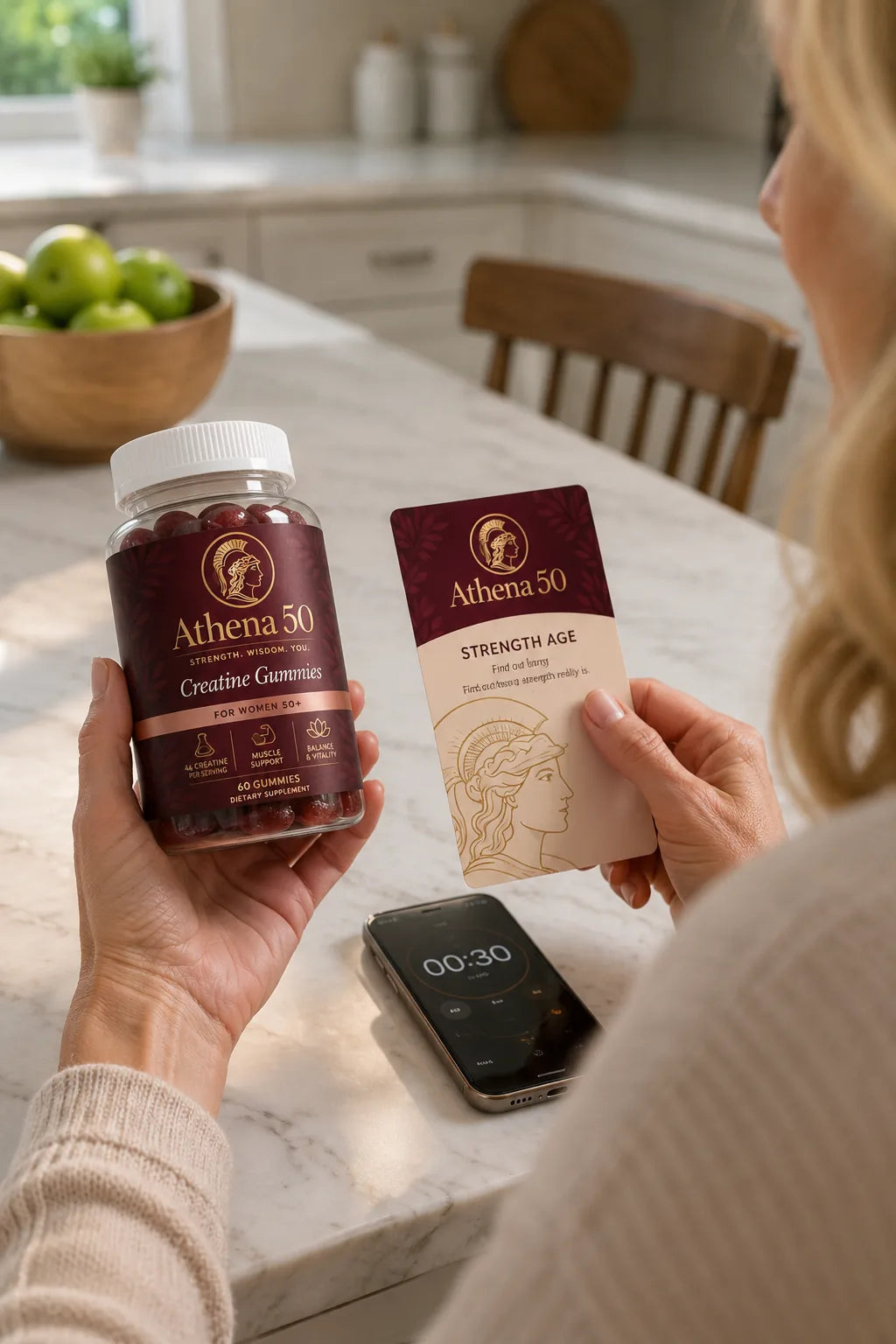 Woman holding the Athena 50 bottle and Strength Age Card